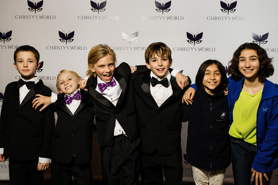  Step and repeat photo of a group of boys in front of a custom background photo taken at a Birthday Party at Hotel Valencia 