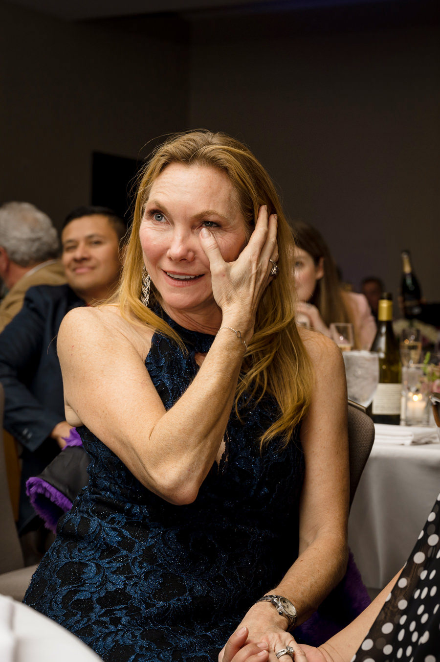 An image of a female overcome with emotion while listening to a speech on her Birthday party at Hotel Valencia