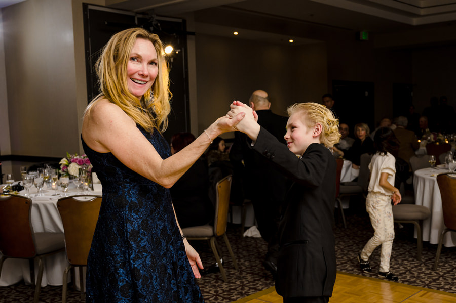 A photo of a lady dancing with her son at her Birthday Party