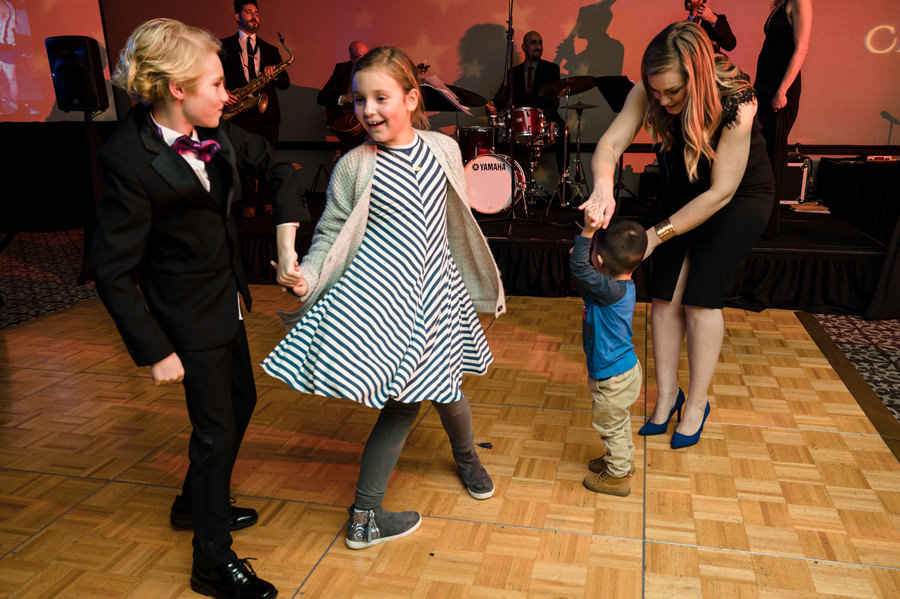 A cute image of kids dancing on the dance floor.