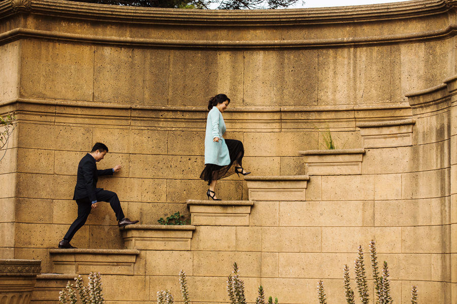 A cute couple climbs up the Palace of Fine Art structure