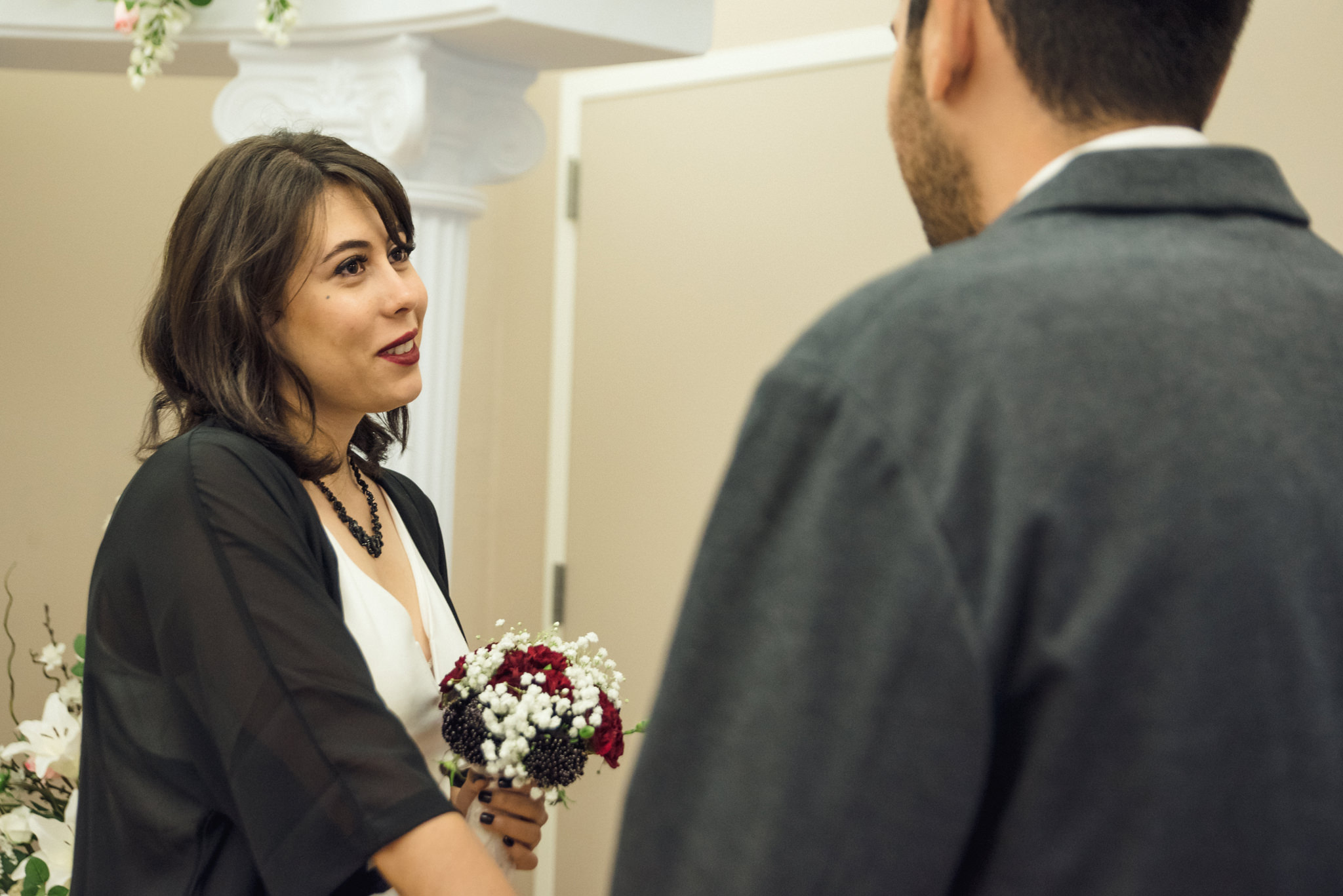A bride looking at her groom on her ceremony at the San Jose Clerk Recording Office backyard
