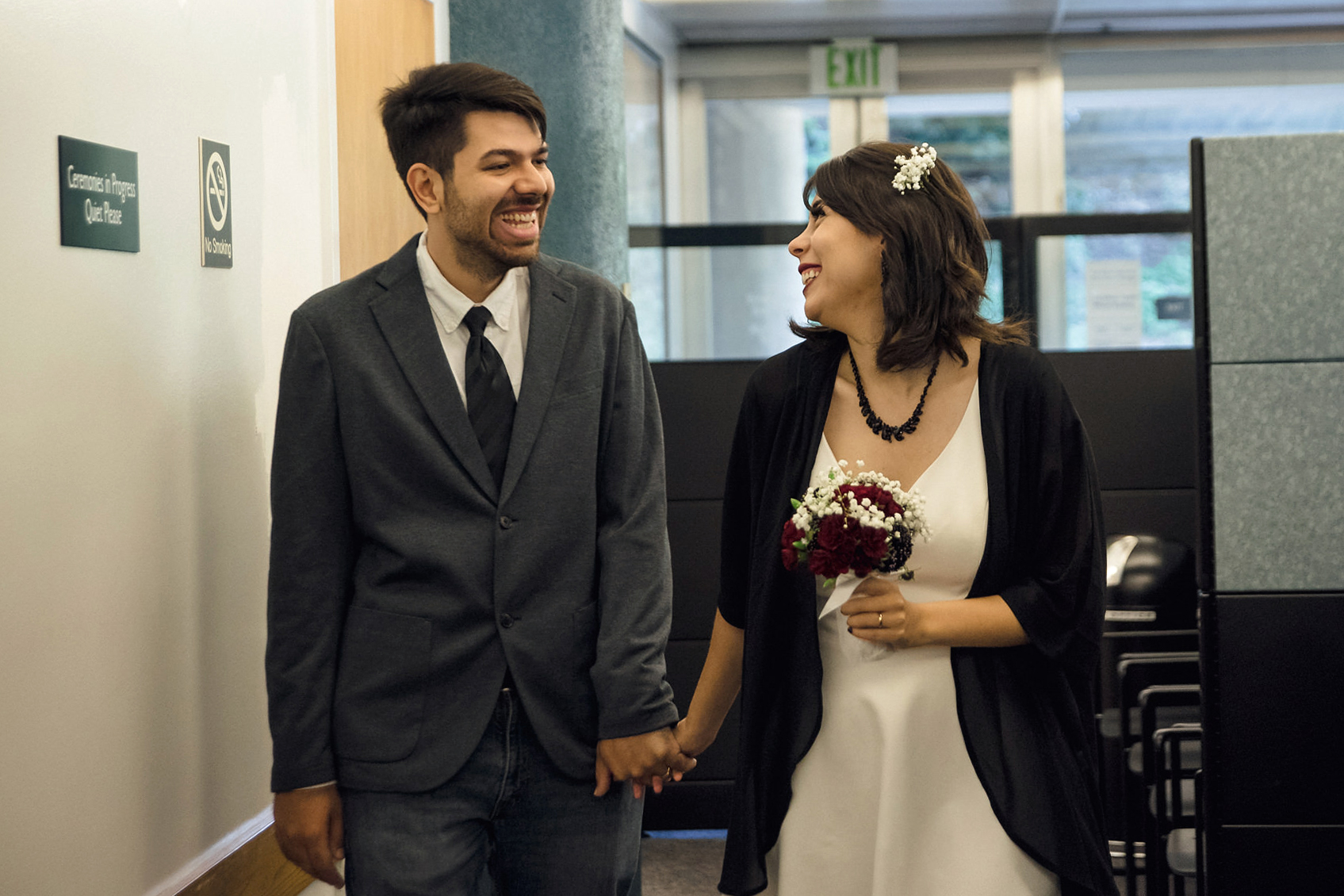A newly wed couple smiling as they left their Wedding ceremony at the San Jose Clerk Recording Office backyard