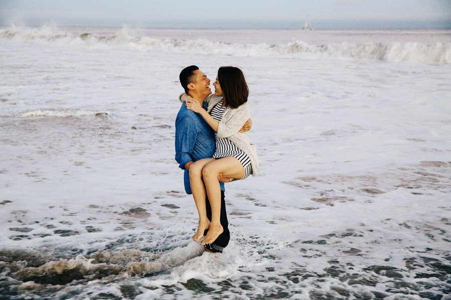 A picture of a man lifts his girlfriend in the water