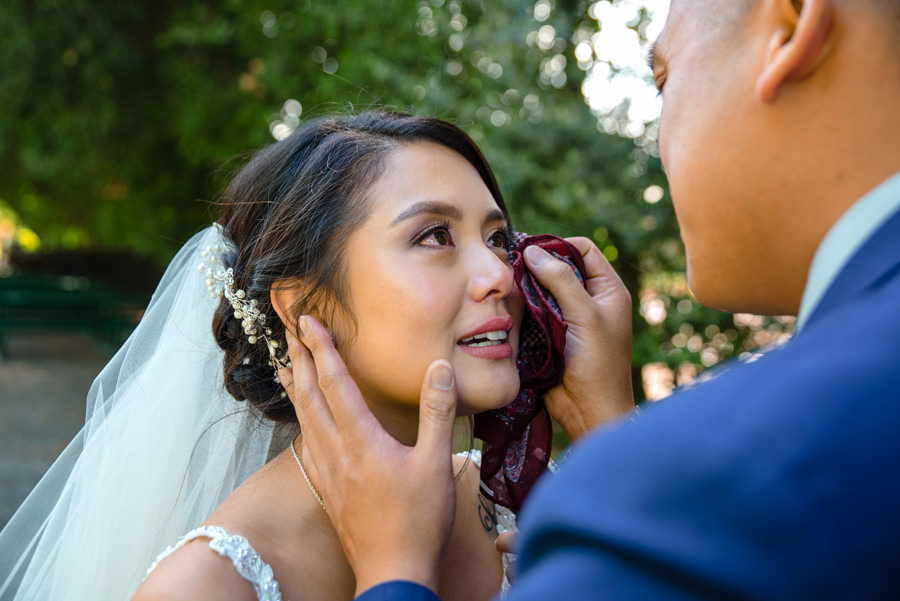 A groom wipe tears of his wife to be at their first look prior to their Wedding at Casa Bella in Sunol, CA.
