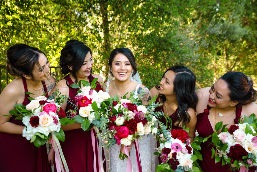 A bride and her bridesmaids pose for the camera