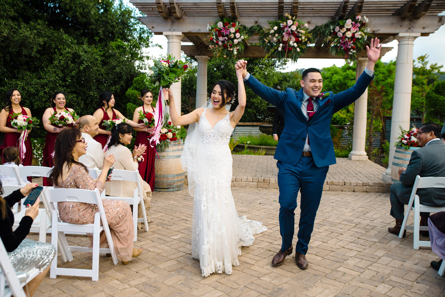A super happy and fun newly wed walked out of the aisle as husband and wife at their Wedding in Casa Bella in Sunol, CA.