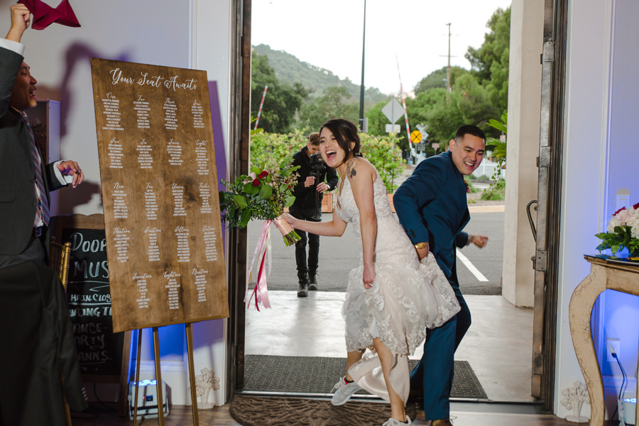 A happy newly wed danced their way into their reception hall