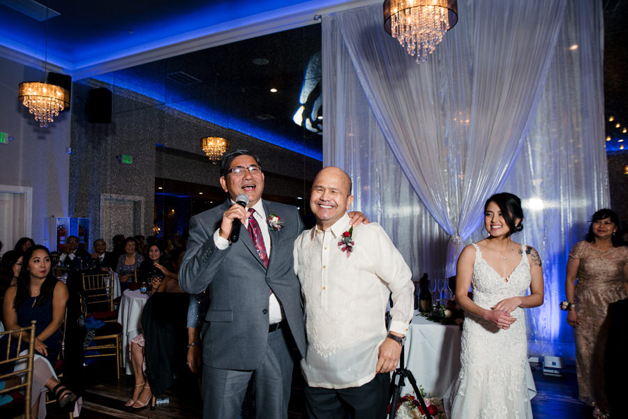 Both fathers of newly wed giving speech at the reception