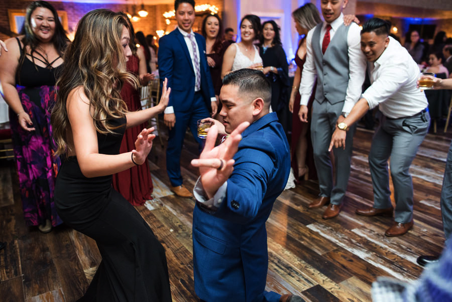 A photo of a groom dancing with his friends at his wedding reception