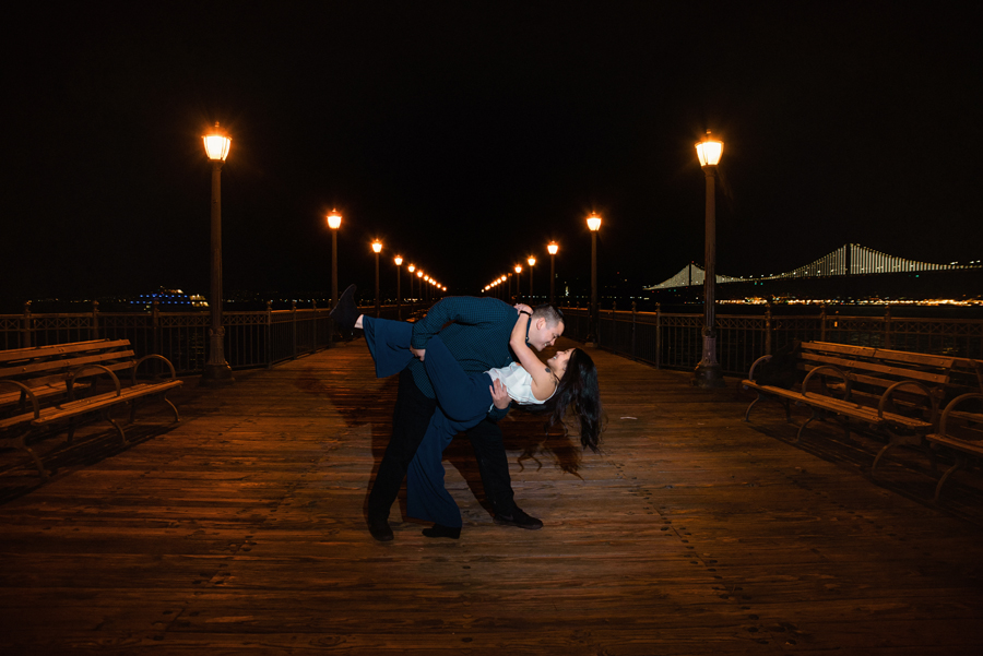 An image of a man dipped his fiance on SF pier taken in the evening