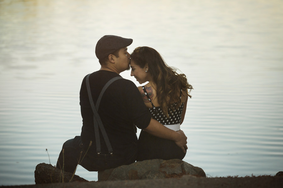 An Artistic photo of a couple in front of a lake