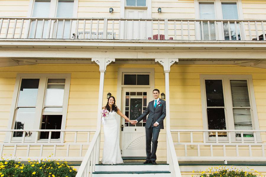 Bride and Groom standing in front of the Guest House for their portrait together after being announced as a husband and wife