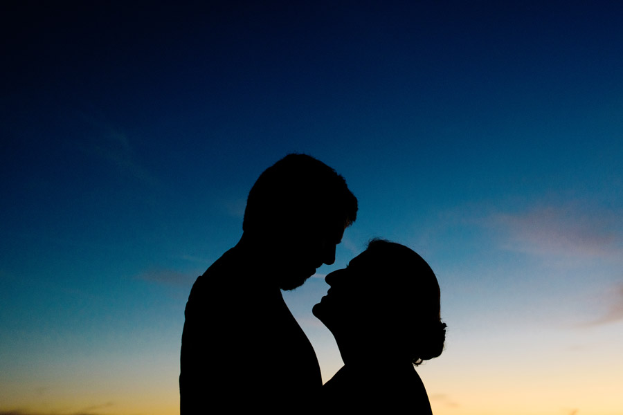 A silhouette shadow of a couple with beautiful Santa Cruz's sunset sky as a background