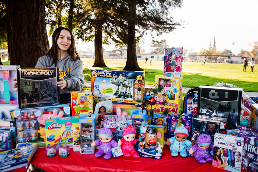 Faith stood in front of her Toys for Tots donations.