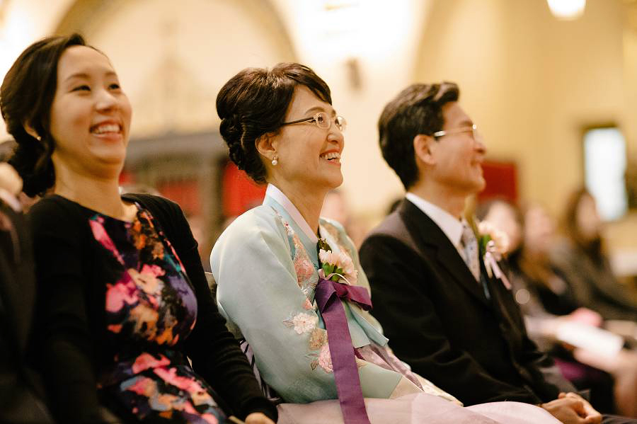 Groom's family laughs during the sermon at Santa Clara University Mission Church Wedding