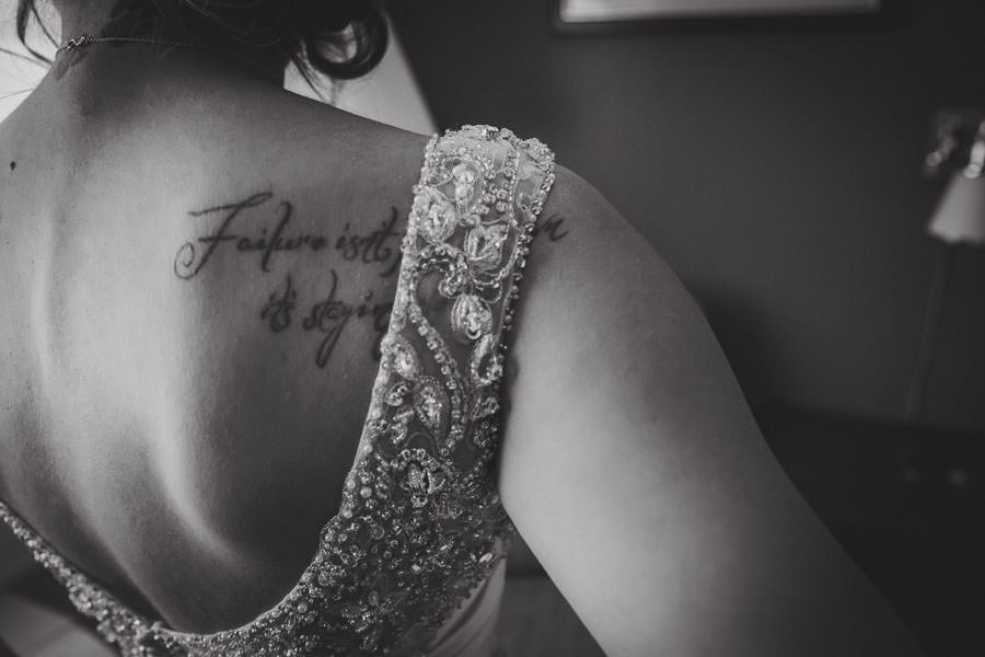 Close up image of a bride's tattoo on her shoulder