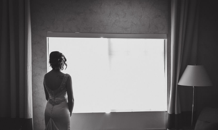 A quiet moment as bride look out to the window