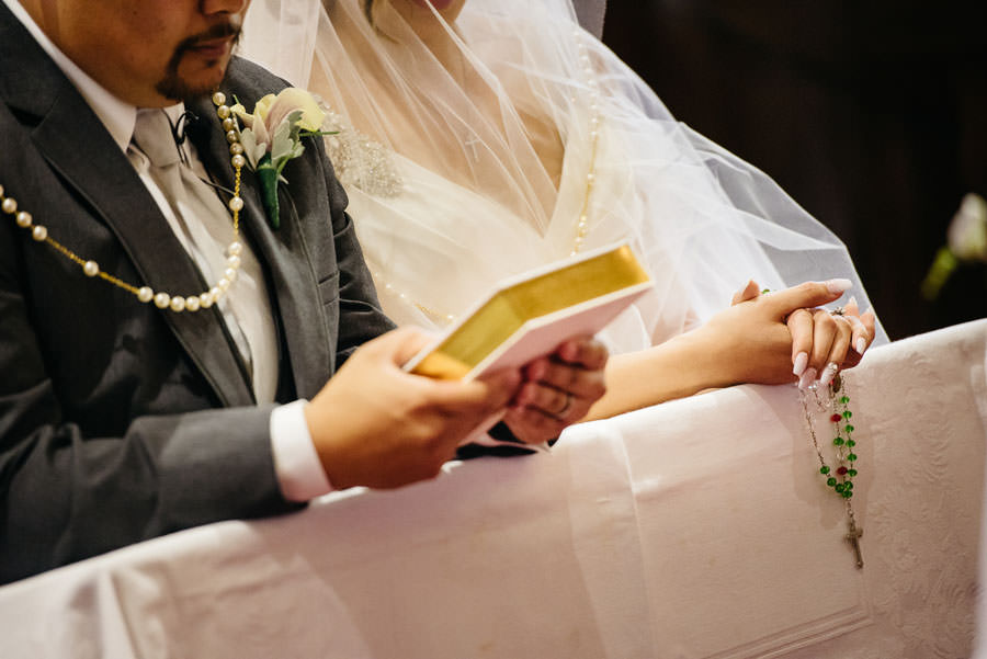 Bride and Groom holding a bible and rosario