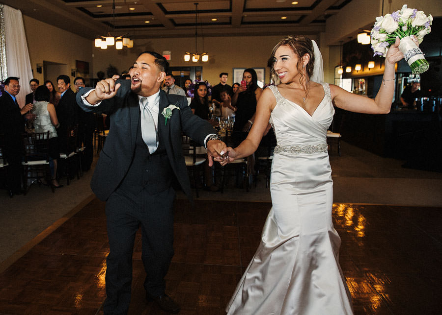 A couple dances as they enter their Wedding Reception