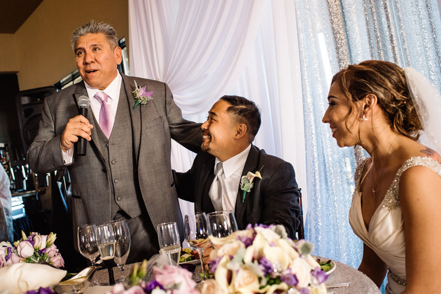 Groom looks up at his Father in Law during the speech