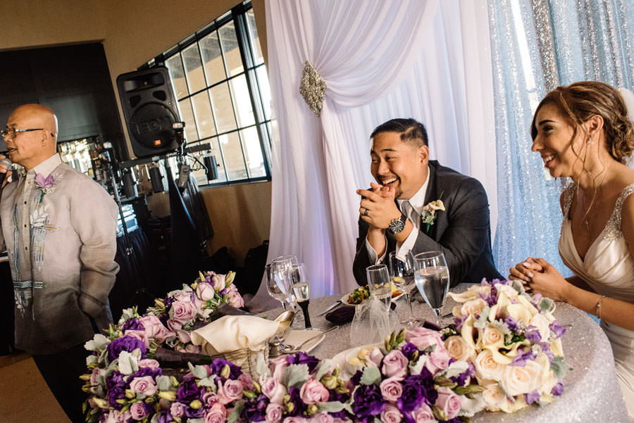A picture of the Wedding couple laughs during the speech