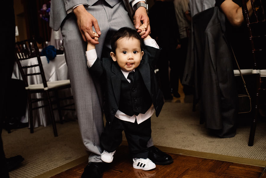 A child being held by his father on the dance floor