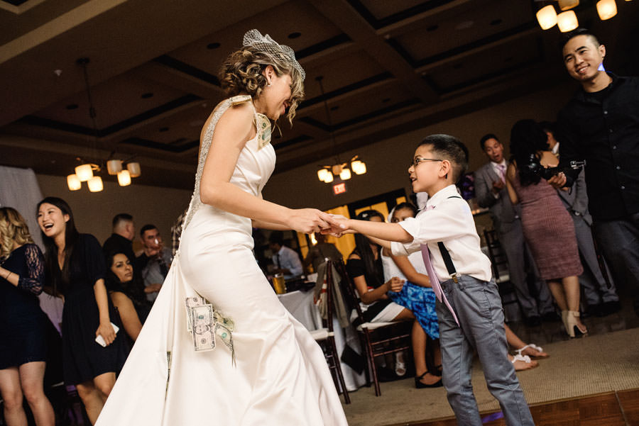 A small guest dances with the bride during the money dance