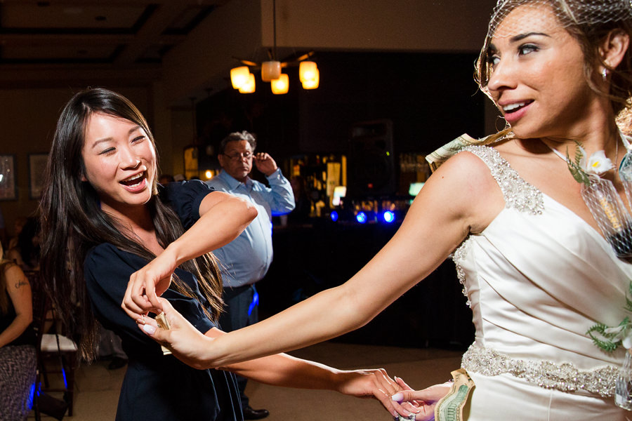 Bride got spun around during money dance by her girlfriend